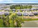 Aerial view of a residential neighborhood with lake views, mature trees and spacious lawns at 1220 Tahitian Sunrise Dr, Plant City, FL 33565