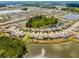 Aerial view of a vibrant community showcasing neighborhood ponds, mature trees, and manicured streetscapes at 1220 Tahitian Sunrise Dr, Plant City, FL 33565