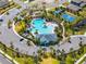 Aerial view of the community pool, playground, and tennis courts surrounded by lush landscaping at 1220 Tahitian Sunrise Dr, Plant City, FL 33565