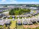 Aerial view of a home showcasing backyard green space, landscaping, and neighborhood ponds at 1220 Tahitian Sunrise Dr, Plant City, FL 33565