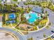Aerial view highlighting community amenities: pool, tennis courts, playground, clubhouse and sidewalks at 1220 Tahitian Sunrise Dr, Plant City, FL 33565