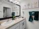 Bathroom featuring double sinks, spacious countertops and teal accents at 1220 Tahitian Sunrise Dr, Plant City, FL 33565