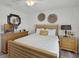 Comfortable bedroom with wood-slat headboard and neutral decor at 1220 Tahitian Sunrise Dr, Plant City, FL 33565
