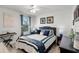 Bright bedroom features a large window, ceiling fan, and decorative wall art at 1220 Tahitian Sunrise Dr, Plant City, FL 33565