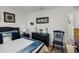Bedroom features a dark wood dresser and a blue accent chair at 1220 Tahitian Sunrise Dr, Plant City, FL 33565