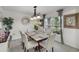 Bright dining room featuring a modern chandelier, large window, and neutral-toned decor at 1220 Tahitian Sunrise Dr, Plant City, FL 33565