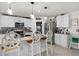 Kitchen with stainless steel appliances, white cabinetry, and breakfast bar seating at 1220 Tahitian Sunrise Dr, Plant City, FL 33565