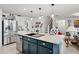 Kitchen island with a sink, seating, and stainless steel appliances nearby at 1220 Tahitian Sunrise Dr, Plant City, FL 33565