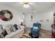 Bright living room features a sofa, blue chair, and unique decorative elements at 1220 Tahitian Sunrise Dr, Plant City, FL 33565