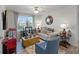 Comfortable living room space, large window view, and home theater decor at 1220 Tahitian Sunrise Dr, Plant City, FL 33565