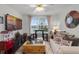 Cozy living room with a view, stylish decor, and lots of movie-themed accessories at 1220 Tahitian Sunrise Dr, Plant City, FL 33565