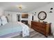 Comfortable main bedroom with a television, dresser, and a view to the closet at 1220 Tahitian Sunrise Dr, Plant City, FL 33565