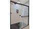 Contemporary shower features a glass door and grey tile at 1220 Tahitian Sunrise Dr, Plant City, FL 33565