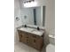 Bathroom featuring double sink vanity with gray and white granite top and black faucets at 12219 Armenia Gables Cir, Tampa, FL 33612