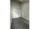Empty bedroom with wood-look flooring, vaulted ceilings, and ample closet space at 12219 Armenia Gables Cir, Tampa, FL 33612