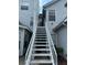 Exterior of home showing staircase leading to the entrance of the home, with light gray siding at 12219 Armenia Gables Cir, Tampa, FL 33612