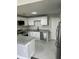 A modern kitchen with white cabinets, granite countertops, and stainless steel appliances at 12219 Armenia Gables Cir, Tampa, FL 33612