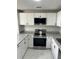 The updated kitchen with granite countertops, white cabinets, and stainless steel appliances at 12219 Armenia Gables Cir, Tampa, FL 33612
