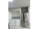 A modern laundry room featuring stainless steel appliances including a refrigerator at 12219 Armenia Gables Cir, Tampa, FL 33612