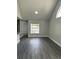 The bright living room features wood floors, neutral paint, and a vaulted ceiling at 12219 Armenia Gables Cir, Tampa, FL 33612