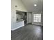 The living room showcases wood floors, a bar, and a window to allow natural light at 12219 Armenia Gables Cir, Tampa, FL 33612