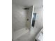 Bathroom shower featuring large, white marble-patterned tile and black fixtures at 12219 Armenia Gables Cir, Tampa, FL 33612