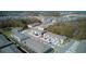 An aerial view of the neighborhood with a pond and lots of new houses at 1570 Hubbell Rd, Wesley Chapel, FL 33543
