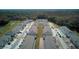 An aerial view showcasing the community layout and proximity to a lush, green forest at 1570 Hubbell Rd, Wesley Chapel, FL 33543