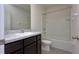 Well-lit bathroom features a vanity, toilet, and shower-tub combination with updated fixtures at 1570 Hubbell Rd, Wesley Chapel, FL 33543