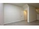 Bright bedroom features neutral walls, modern tile floor and a door leading to adjoining spaces at 1570 Hubbell Rd, Wesley Chapel, FL 33543