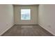 Bedroom view with neutral carpeting and a window providing natural light at 1570 Hubbell Rd, Wesley Chapel, FL 33543
