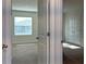 Sunlit bedroom view showcasing neutral carpeting and natural light through window at 1570 Hubbell Rd, Wesley Chapel, FL 33543