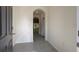 Inviting entryway with neutral colored walls, tile flooring, leading into open living space, and a transom doorway at 1570 Hubbell Rd, Wesley Chapel, FL 33543