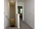 Upstairs hallway with neutral walls, carpeted floor, and railing leading to bedrooms, with natural light at 1570 Hubbell Rd, Wesley Chapel, FL 33543