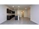 Well-equipped kitchen featuring stainless steel appliances, granite counters, breakfast bar, and open floor plan at 1570 Hubbell Rd, Wesley Chapel, FL 33543