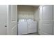 Convenient laundry room equipped with modern washer and dryer units and storage shelf at 1570 Hubbell Rd, Wesley Chapel, FL 33543