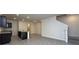 Open concept living room with staircase, transom doorway to living room, and seamless flow to kitchen at 1570 Hubbell Rd, Wesley Chapel, FL 33543