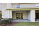 A covered patio with sliding glass doors provides a seamless transition to outdoor living at 1570 Hubbell Rd, Wesley Chapel, FL 33543