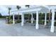 Relaxing pool area with stylish lounge chairs under a pergola, perfect for residents at 1570 Hubbell Rd, Wesley Chapel, FL 33543