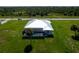 Aerial view of the home showcasing its pool, modern roofline, and screened enclosure at 205 Rotonda S Blvd, Rotonda West, FL 33947