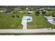 Aerial view showing home on large lot with well-maintained lawn and landscaping at 205 Rotonda S Blvd, Rotonda West, FL 33947