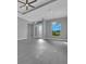 Bright and open living room with gray walls, tiled floor, and a large double door at the front at 205 Rotonda S Blvd, Rotonda West, FL 33947