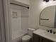 Bathroom with modern fixtures, white tiling, and a shower-tub combo at 2055 Lakeview Dr, Clearwater, FL 33763