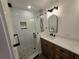 Bathroom featuring a glass enclosed shower and wood vanity at 2055 Lakeview Dr, Clearwater, FL 33763