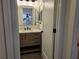 Bathroom view showing a vanity with marble top and contemporary mirror at 2055 Lakeview Dr, Clearwater, FL 33763