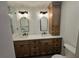 Bathroom featuring dual sinks, a tower cabinet, and modern fixtures at 2055 Lakeview Dr, Clearwater, FL 33763