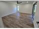 Spacious bedroom featuring hardwood floors, ample natural light, and sliding glass door to the backyard at 2055 Lakeview Dr, Clearwater, FL 33763
