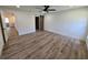 Bedroom featuring wood-look floors, a modern ceiling fan, and a sliding barn door at 2055 Lakeview Dr, Clearwater, FL 33763