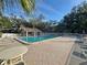 Community pool area with lounge chairs, tables, and a pool house at 2055 Lakeview Dr, Clearwater, FL 33763