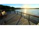 A wooden dock extends onto the tranquil water, providing a peaceful spot to enjoy the waterfront view and the sunrise at 2055 Lakeview Dr, Clearwater, FL 33763